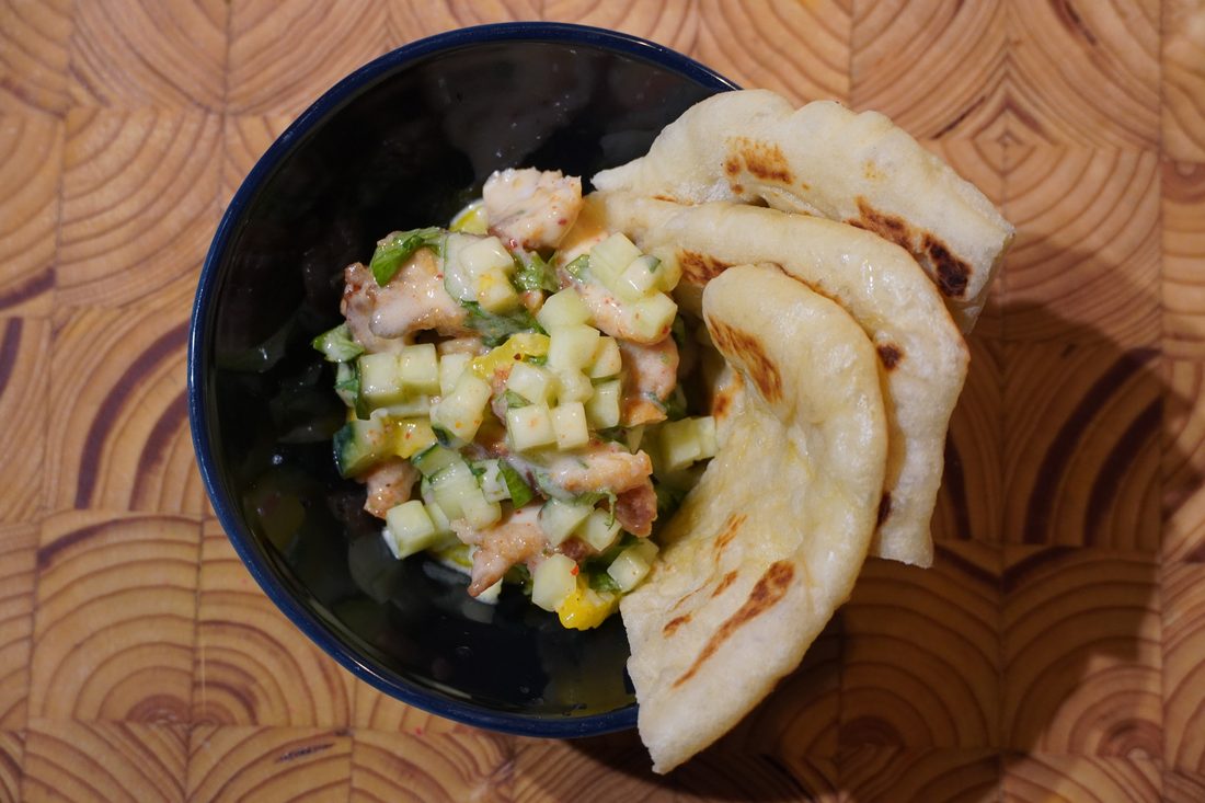 Housemade pita with chicken, yogurt, and cucumber, overhead view